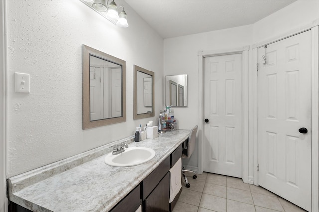 bathroom featuring tile patterned flooring and vanity