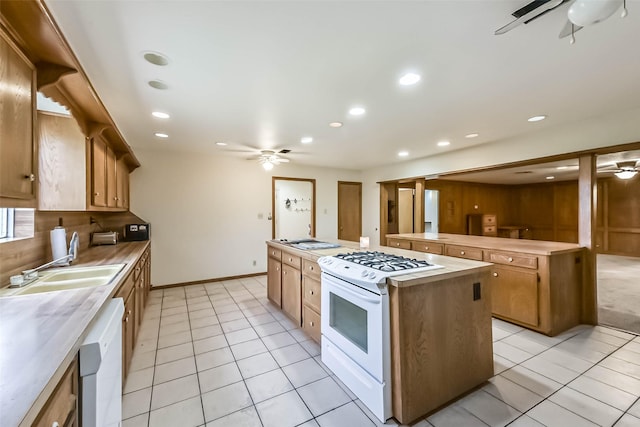 kitchen featuring ceiling fan, light tile patterned flooring, recessed lighting, white appliances, and a kitchen island