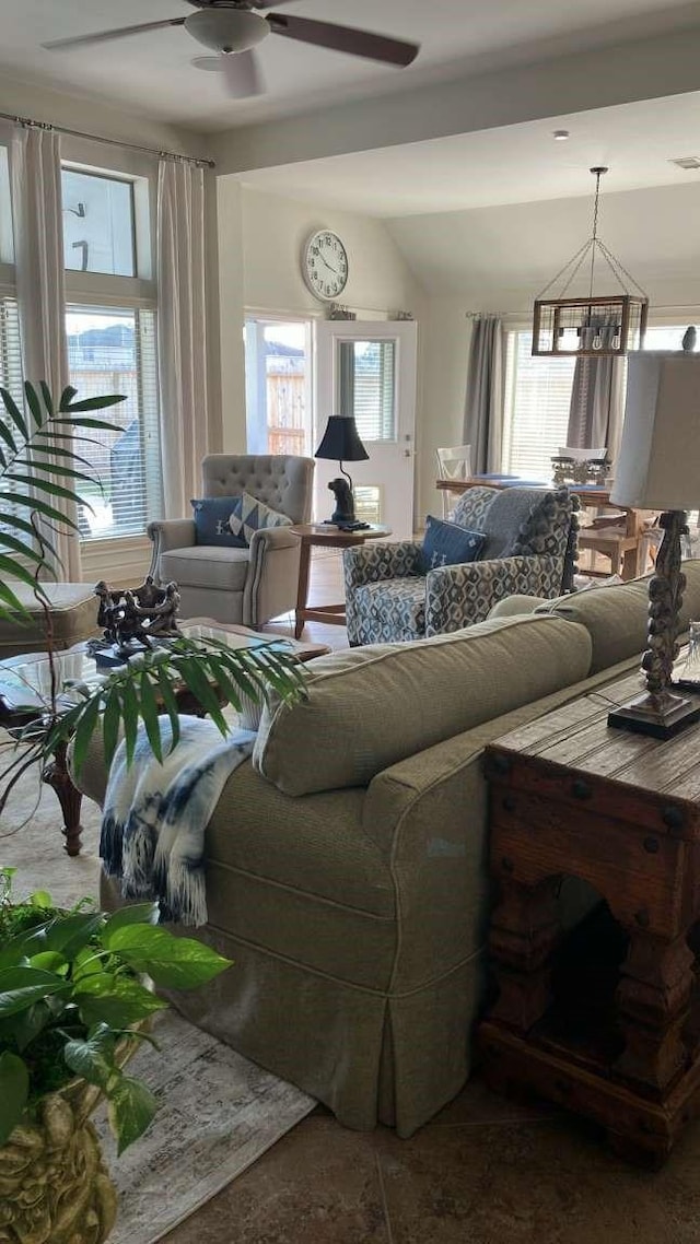 living room with ceiling fan and vaulted ceiling