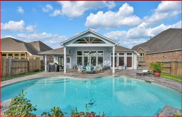 rear view of property with a fenced backyard, a fenced in pool, and a patio