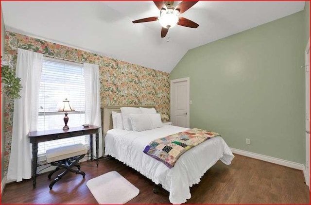 bedroom with wallpapered walls, lofted ceiling, wood finished floors, baseboards, and ceiling fan