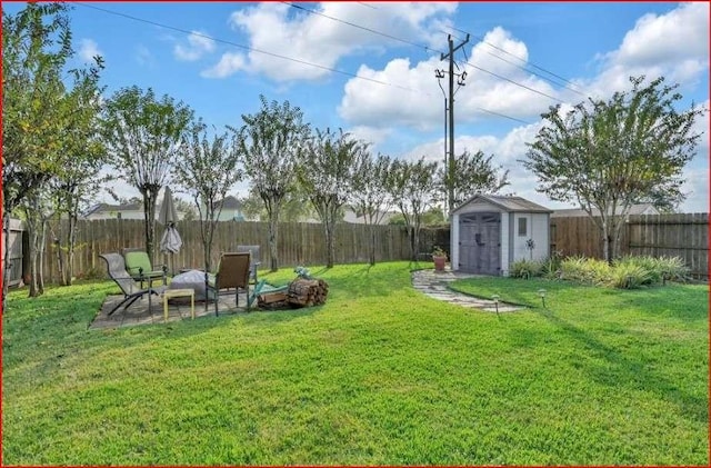 view of yard featuring a fenced backyard, an outdoor structure, and a shed