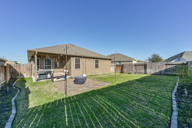 rear view of property with an outdoor living space, a patio area, a lawn, and a fenced backyard