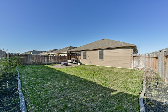 back of house with a fenced backyard, a patio, and a yard