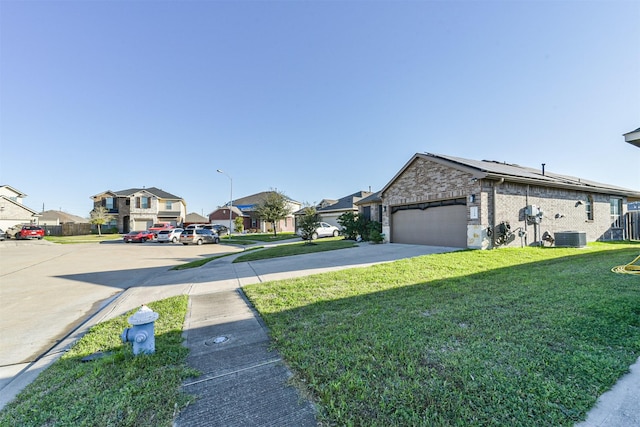 exterior space featuring an attached garage, brick siding, concrete driveway, a residential view, and a front lawn