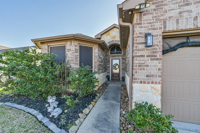 property entrance with stone siding and brick siding