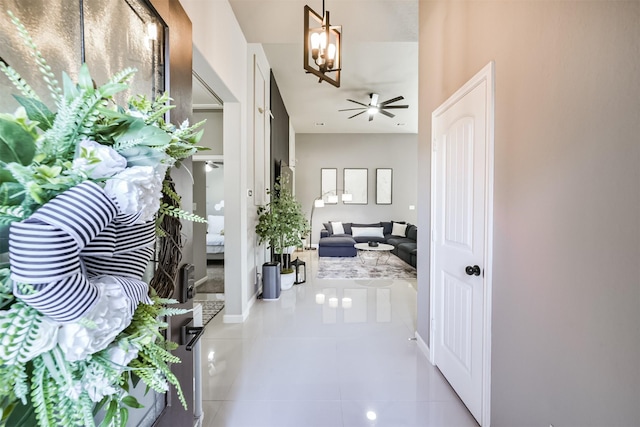 corridor with baseboards and tile patterned floors