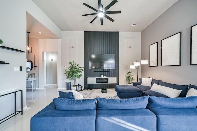 living area featuring a ceiling fan