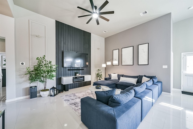 tiled living area with ceiling fan, visible vents, and baseboards