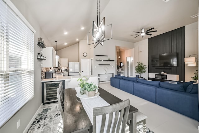 dining area with baseboards, ceiling fan, wine cooler, high vaulted ceiling, and recessed lighting