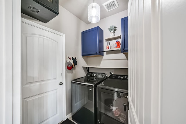 laundry area with cabinet space, visible vents, and washer and clothes dryer