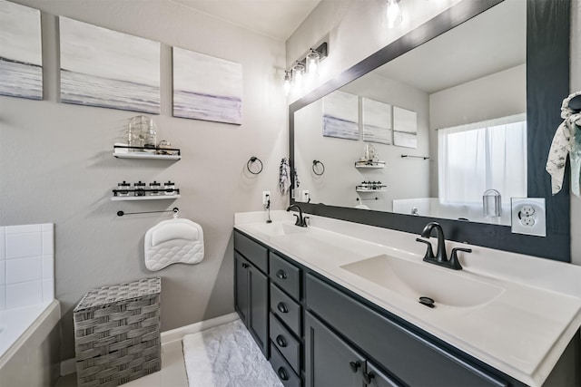 bathroom featuring baseboards, a sink, a bathing tub, and double vanity