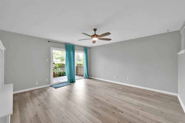 empty room featuring ceiling fan, light wood-type flooring, and baseboards