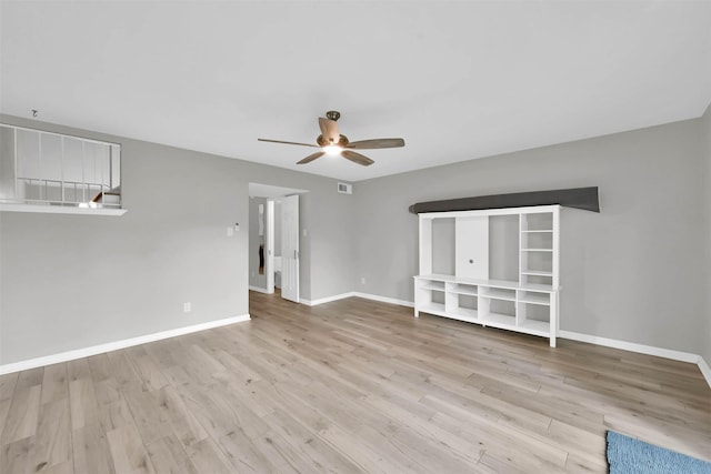 spare room with a ceiling fan, baseboards, and wood finished floors