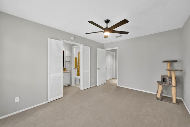 unfurnished bedroom featuring visible vents, carpet flooring, connected bathroom, ceiling fan, and baseboards