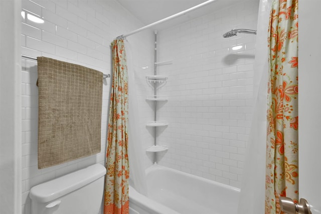 bathroom featuring shower / bath combination with curtain and toilet