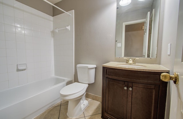 bathroom with tile patterned flooring, toilet, vanity, baseboards, and shower / washtub combination