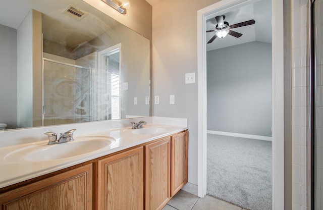 bathroom featuring double vanity, a stall shower, a sink, and visible vents