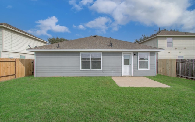 back of property with a patio area, a fenced backyard, a lawn, and roof with shingles