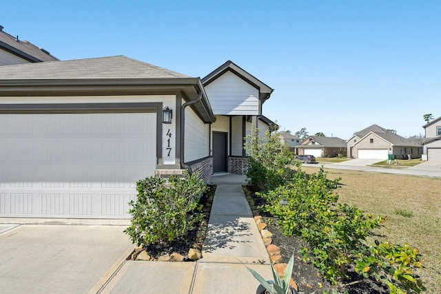 view of front of home with a garage and a shingled roof