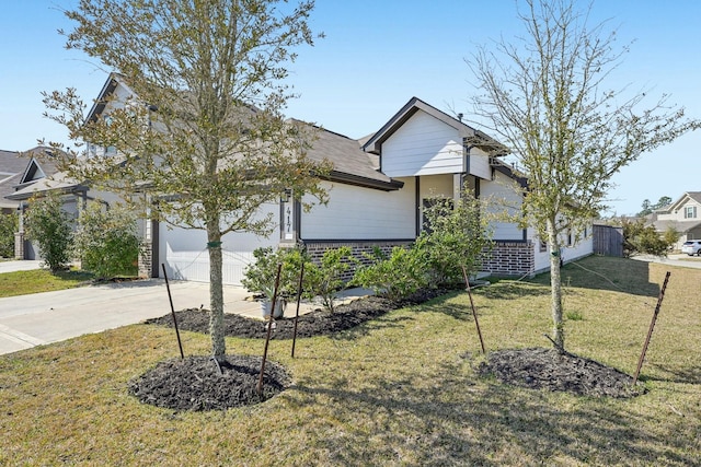 view of front of property with a garage, concrete driveway, and a front lawn