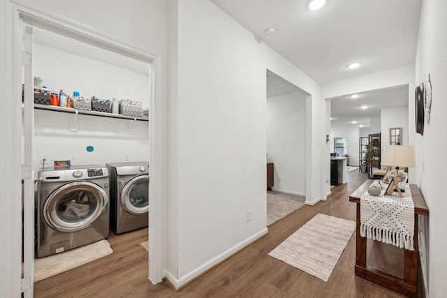 laundry room with recessed lighting, wood finished floors, laundry area, independent washer and dryer, and baseboards