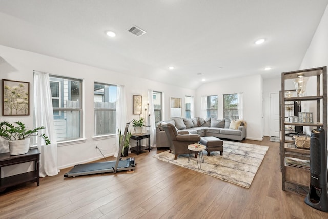 living room with lofted ceiling, recessed lighting, visible vents, wood finished floors, and baseboards