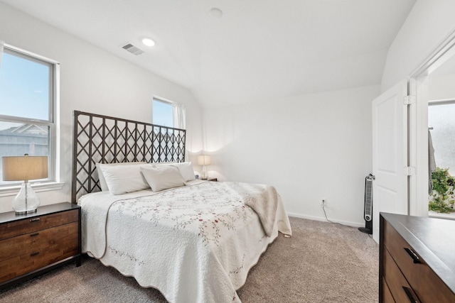 bedroom featuring baseboards, visible vents, vaulted ceiling, and carpet flooring