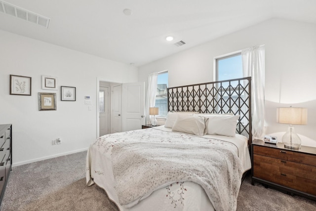 bedroom featuring carpet floors, baseboards, visible vents, and vaulted ceiling