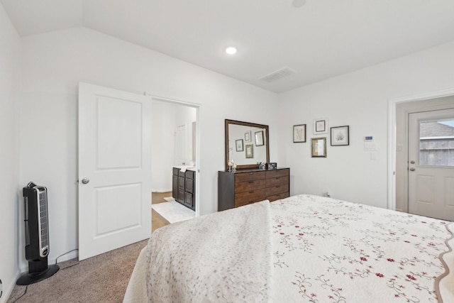 carpeted bedroom featuring lofted ceiling and visible vents