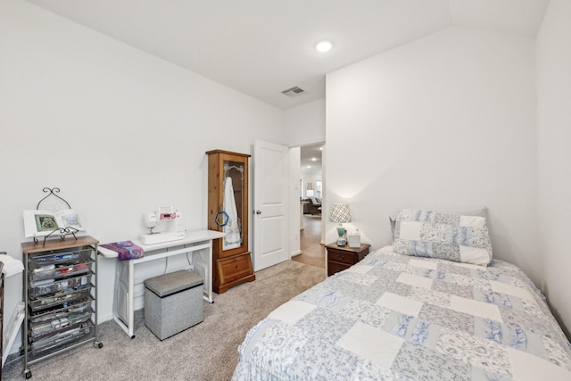 bedroom featuring light carpet, lofted ceiling, and visible vents