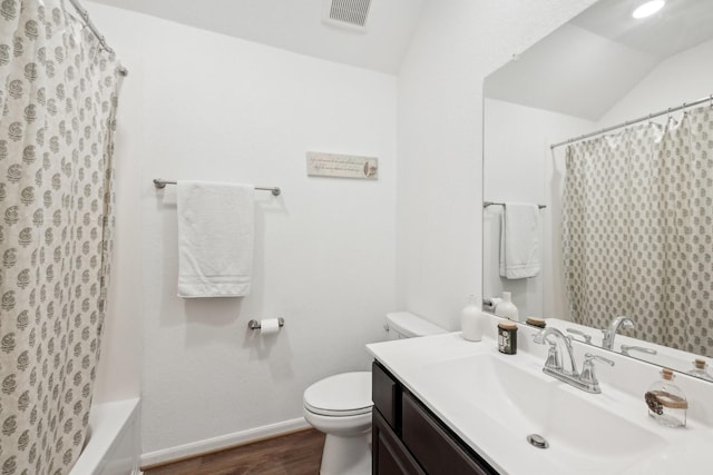 full bath with baseboards, visible vents, toilet, wood finished floors, and vaulted ceiling