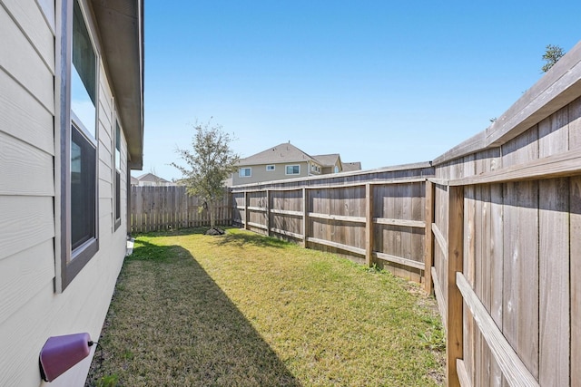 view of yard with a fenced backyard