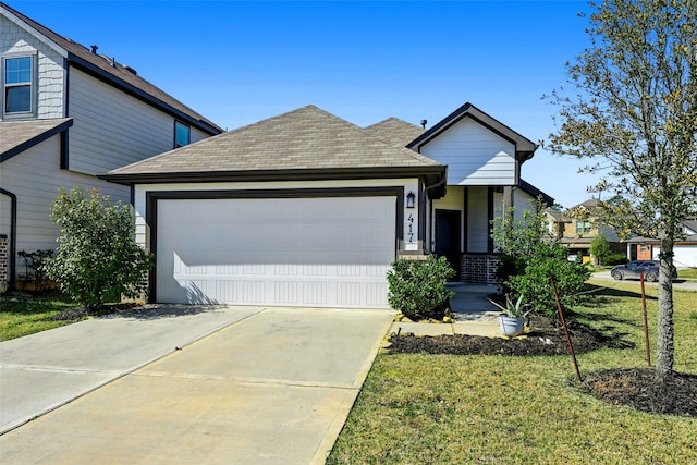 view of front of house featuring a garage, a front yard, driveway, and a shingled roof