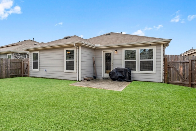 back of house featuring a fenced backyard, a shingled roof, a lawn, and a patio