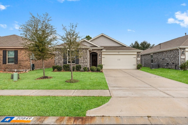 view of front of home with central air condition unit, a garage, brick siding, concrete driveway, and a front yard