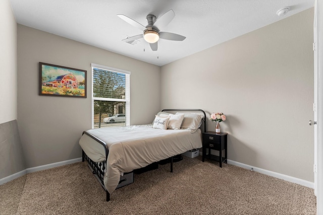 carpeted bedroom featuring ceiling fan and baseboards