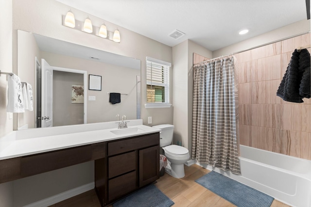 full bathroom with visible vents, toilet, shower / bath combo, vanity, and wood finished floors