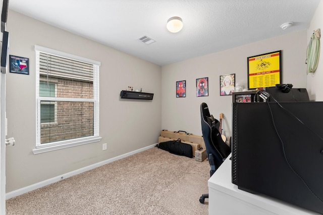 carpeted office with baseboards, visible vents, and a textured ceiling