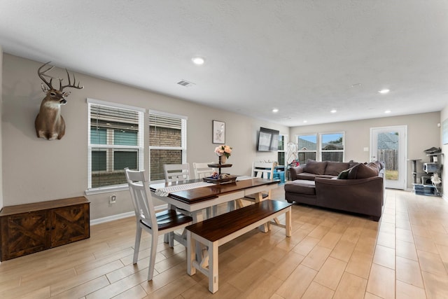 dining room with light wood-style flooring, visible vents, and recessed lighting