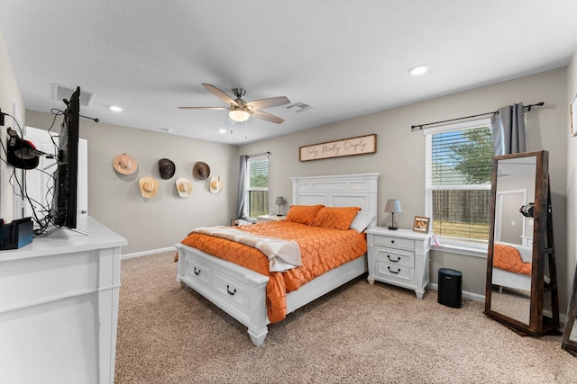 bedroom with baseboards, visible vents, a ceiling fan, and light colored carpet