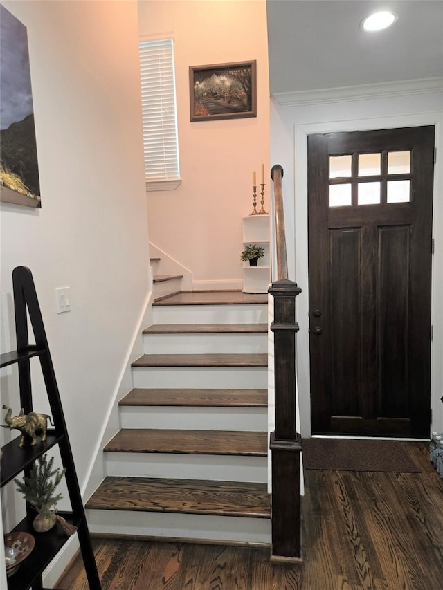 foyer entrance with recessed lighting, stairway, crown molding, and wood finished floors