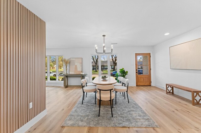 dining room featuring baseboards, light wood finished floors, recessed lighting, and an inviting chandelier