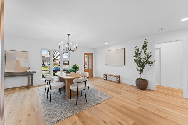 dining area featuring light wood-style floors, recessed lighting, baseboards, and an inviting chandelier