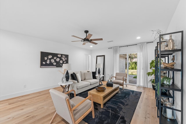 living room featuring baseboards, wood finished floors, visible vents, and recessed lighting