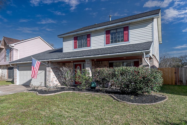 traditional home with driveway, an attached garage, a front lawn, and fence