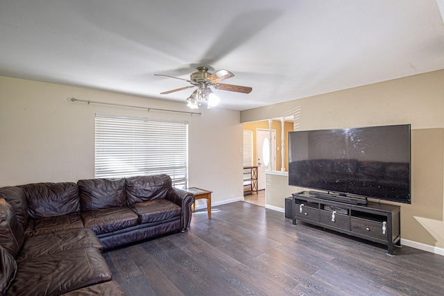 living room with baseboards, wood finished floors, and a ceiling fan