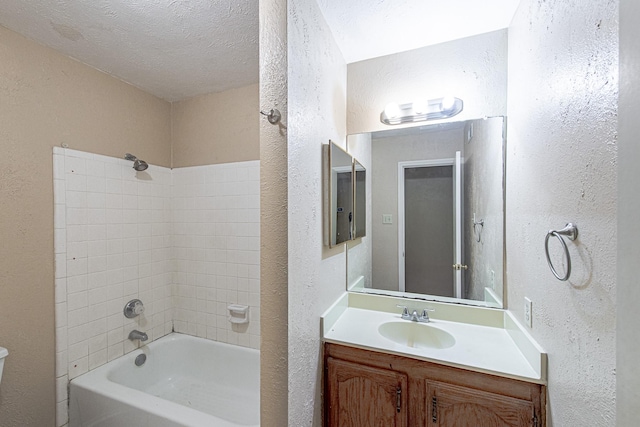 bathroom featuring vanity, a textured ceiling, shower / tub combination, toilet, and a textured wall