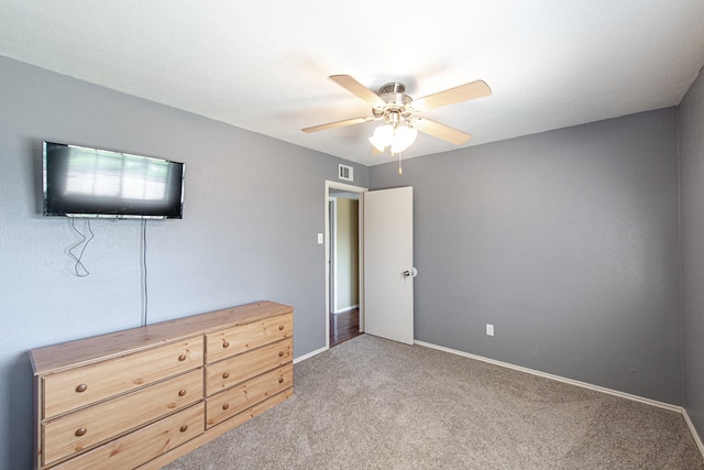 unfurnished bedroom featuring carpet flooring, baseboards, visible vents, and ceiling fan