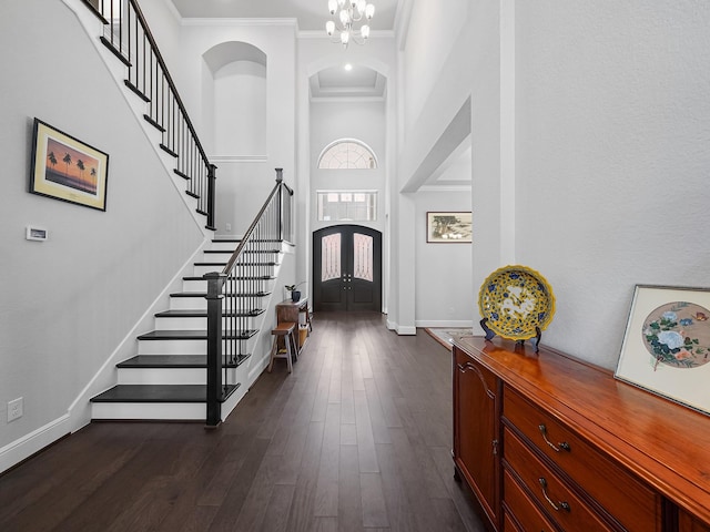 entryway featuring dark wood-type flooring, stairway, french doors, and ornamental molding